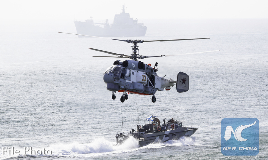 Russian navy ships and a helicopter take a part in a landing operation during military drills at the Black Sea coast, Crimea, Sept. 9, 2016. (AP Photo)