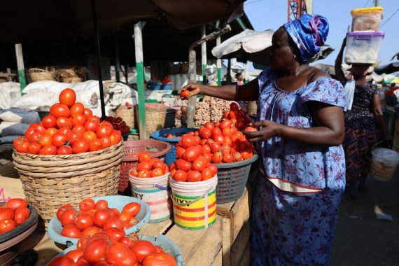 A vendor sells food at a market in Accra, capital of Ghana, March 15, 2023. (Photo by Seth/Xinhua)
